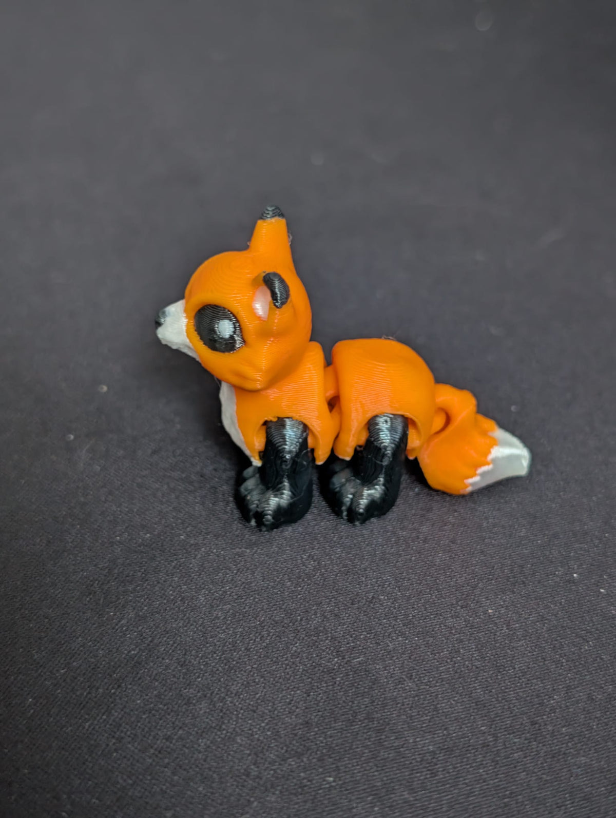 Orange Fox articulate toy on dark background