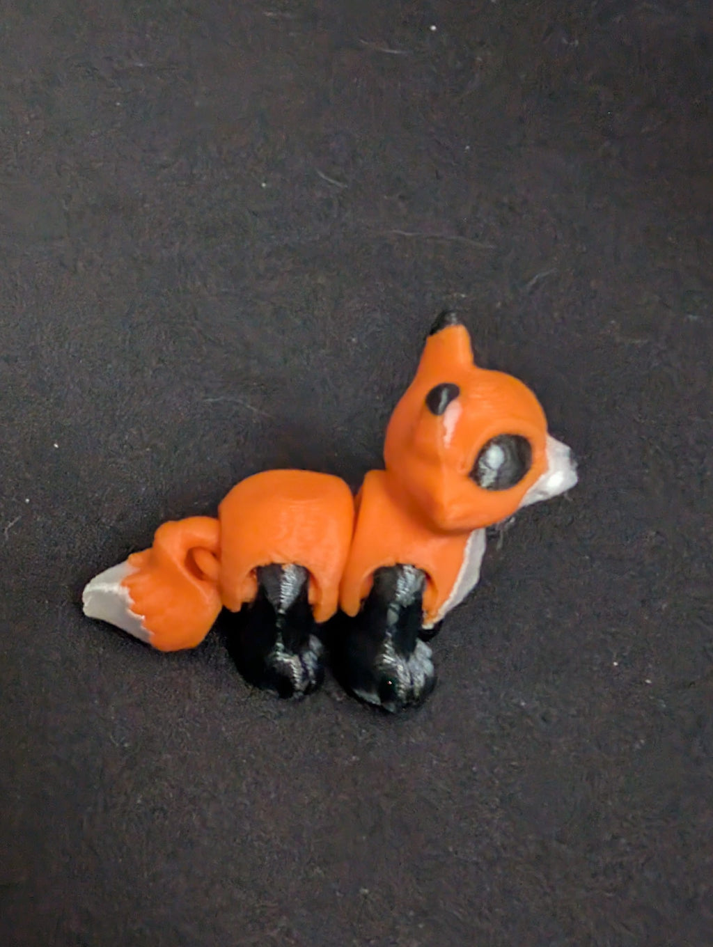 Orange Fox articulate toy on dark background