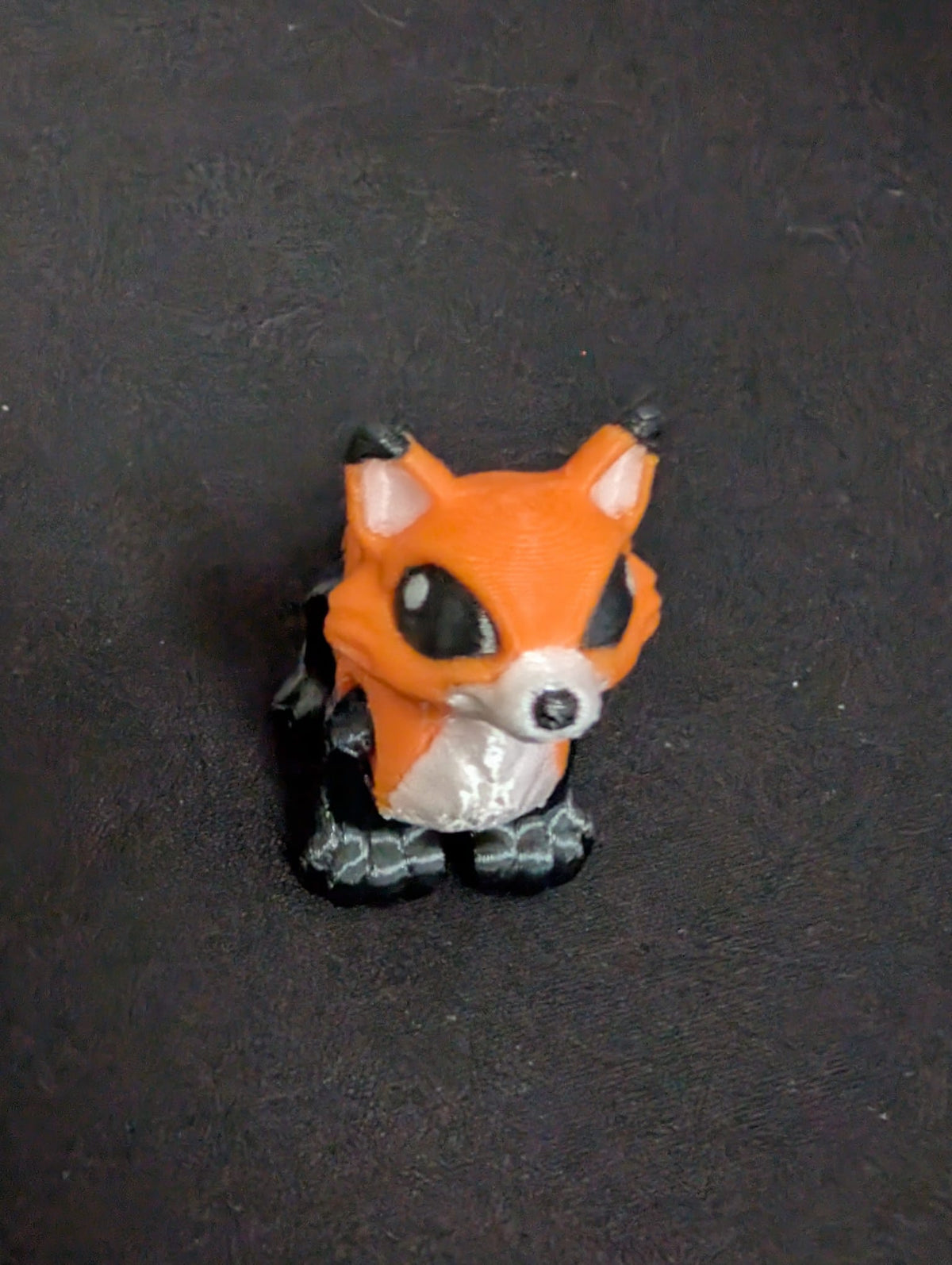 Orange Fox articulate toy on dark background